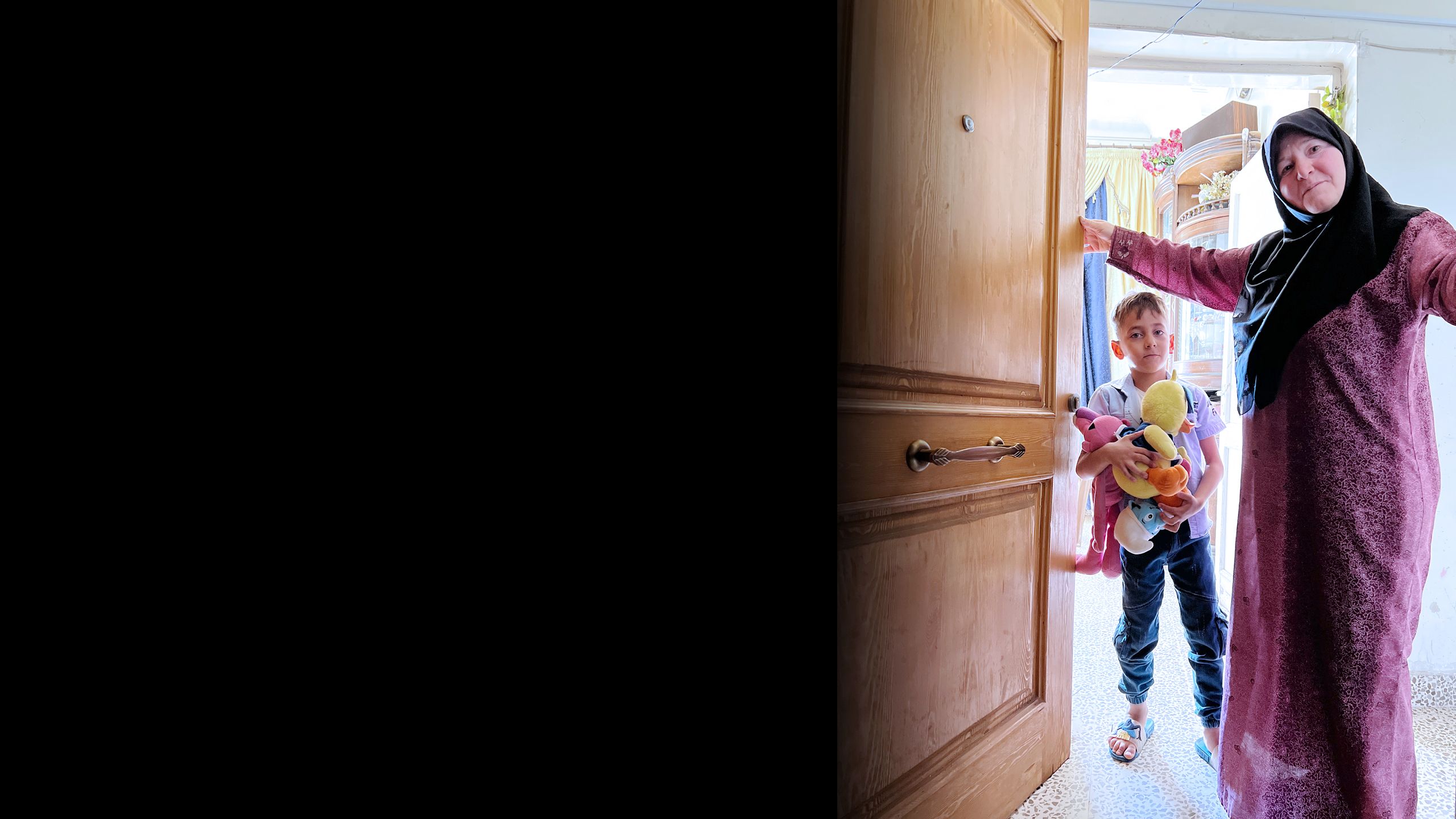 Grandmother and grandson opening the door